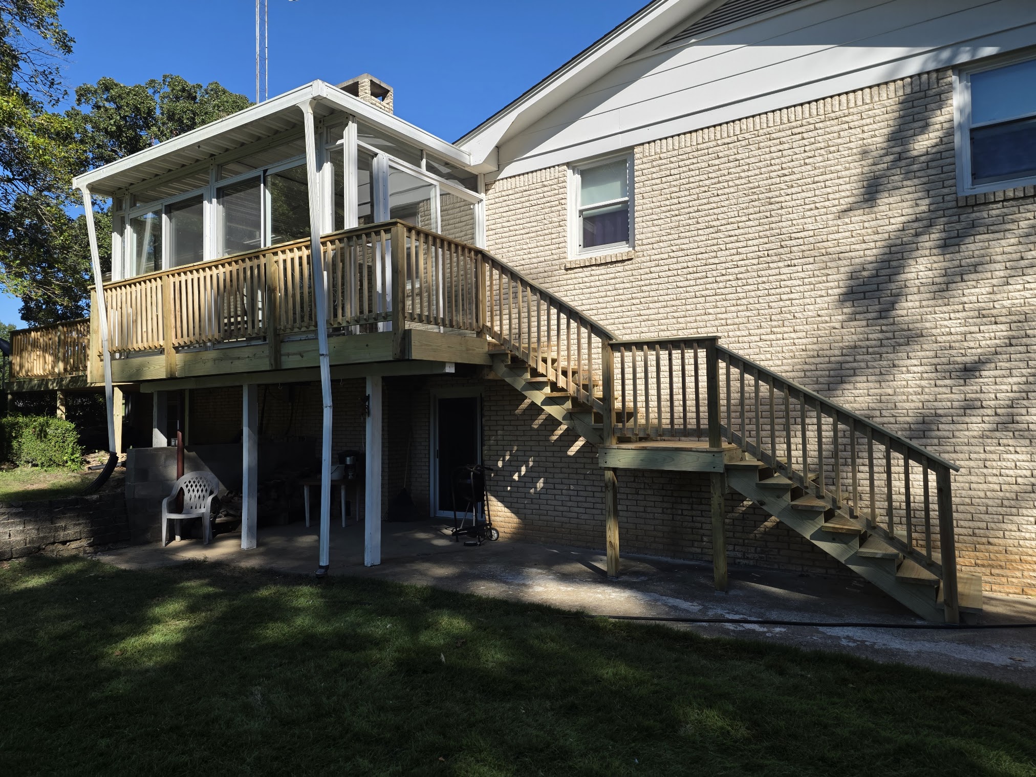 Raised deck with screened porch and long exterior staircase