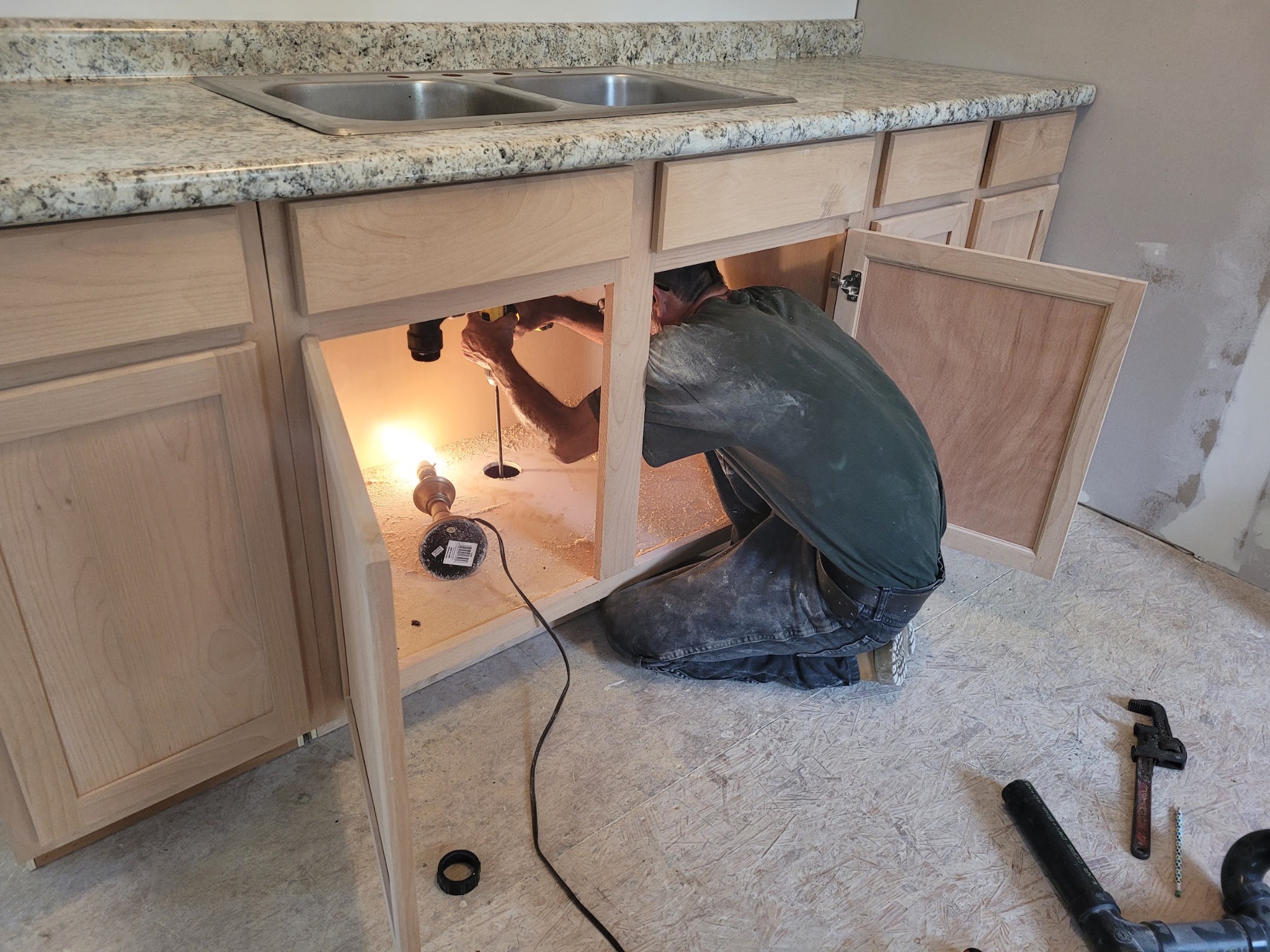 Handy Hands working on sink plumbing