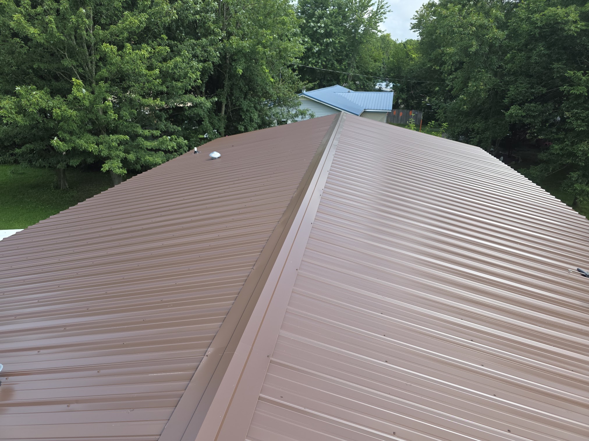 Metal roof ridge and finished panels